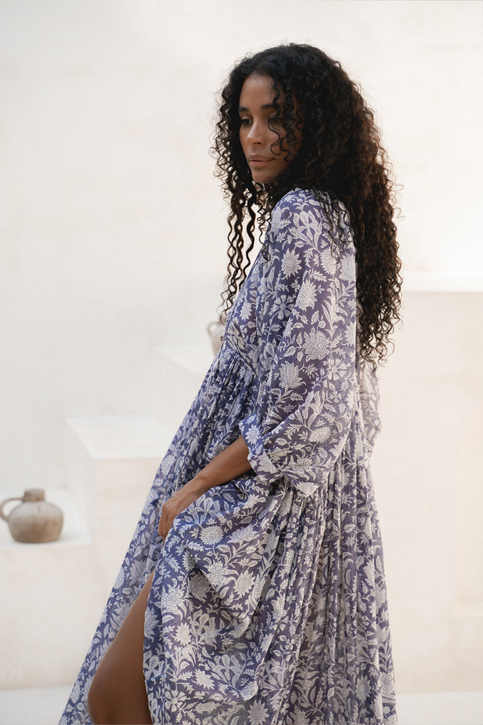 Kyra Midi Dress Blue Iris — full length over-shoulder lifestyle shot, hand block print floral cotton | Daughters of India