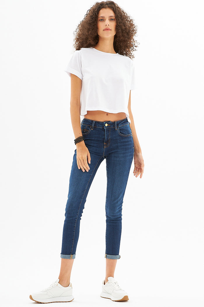 White Leah Ribbed Crop Top styled with dark wash skinny jeans and sneakers, a Gen Z summer streetwear essential.
