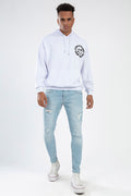 Model wearing Leon Light Blue Super Skinny Fit distressed jeans with a white hoodie and sneakers for a streetwear look.