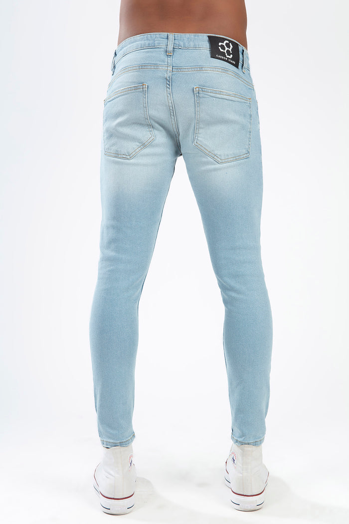Rear view of Leon light blue super skinny fit streetwear jeans with Carbon Jeans patch and back pocket detailing.