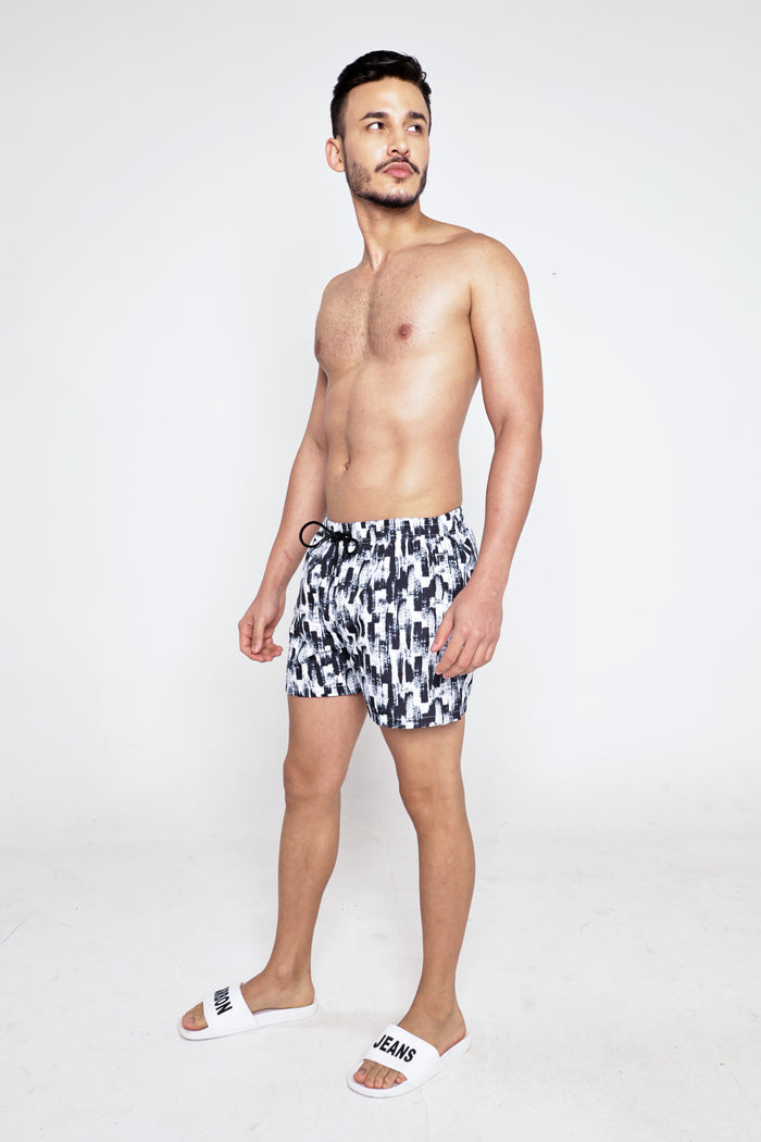 Men's Leonardo patterned swim trunks with black and white abstract print, featuring an elastic drawstring waistband.