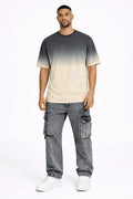 Model wearing Lewis grey washed baggy denim cargo pants with distressed details and a streetwear gradient t-shirt.