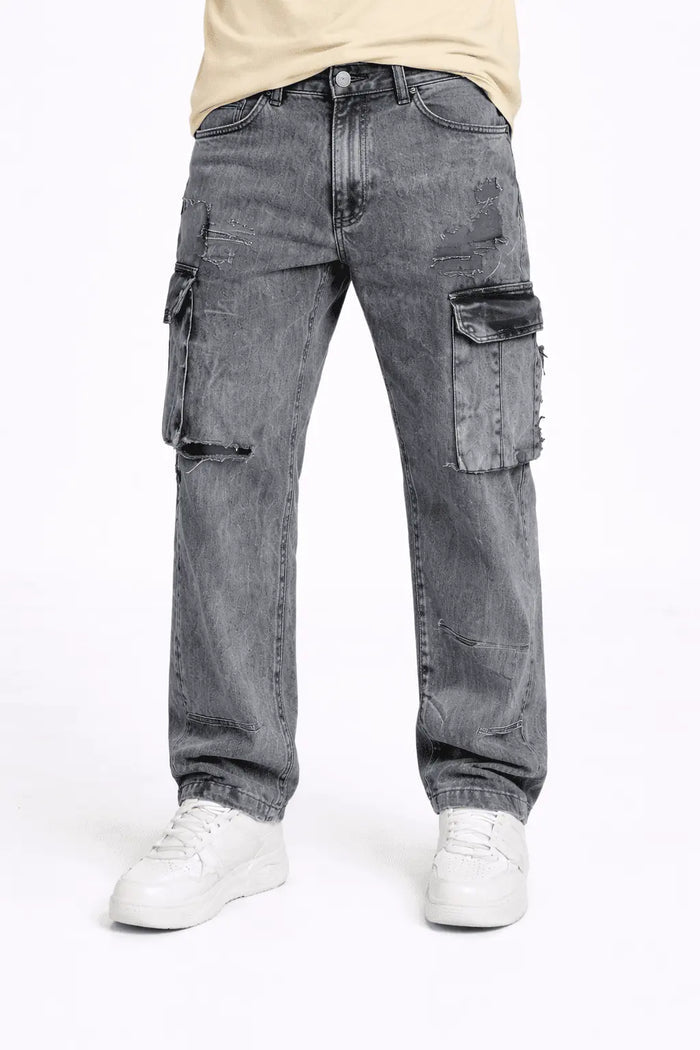 Model wearing Lewis grey washed baggy denim cargo pants with distressed details and streetwear aesthetic.