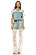 Light wash denim two-piece pant set with a matching short sleeve top and white crochet lace overlay on the wide-leg pants.