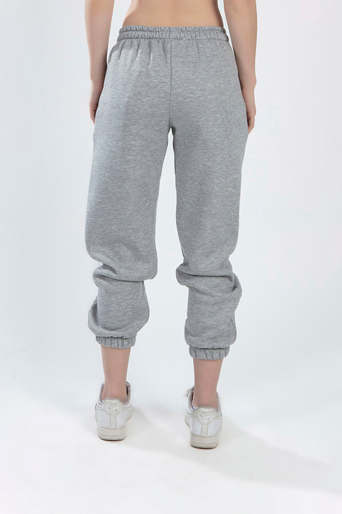 Back view of Lily light grey heather sweatpants with elastic waistband and cuffed ankles for a trendy streetwear look.