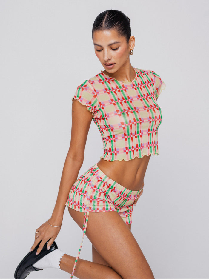 This is an image of Micro Shorts in Plaid - RESA featuring a model wearing the dress