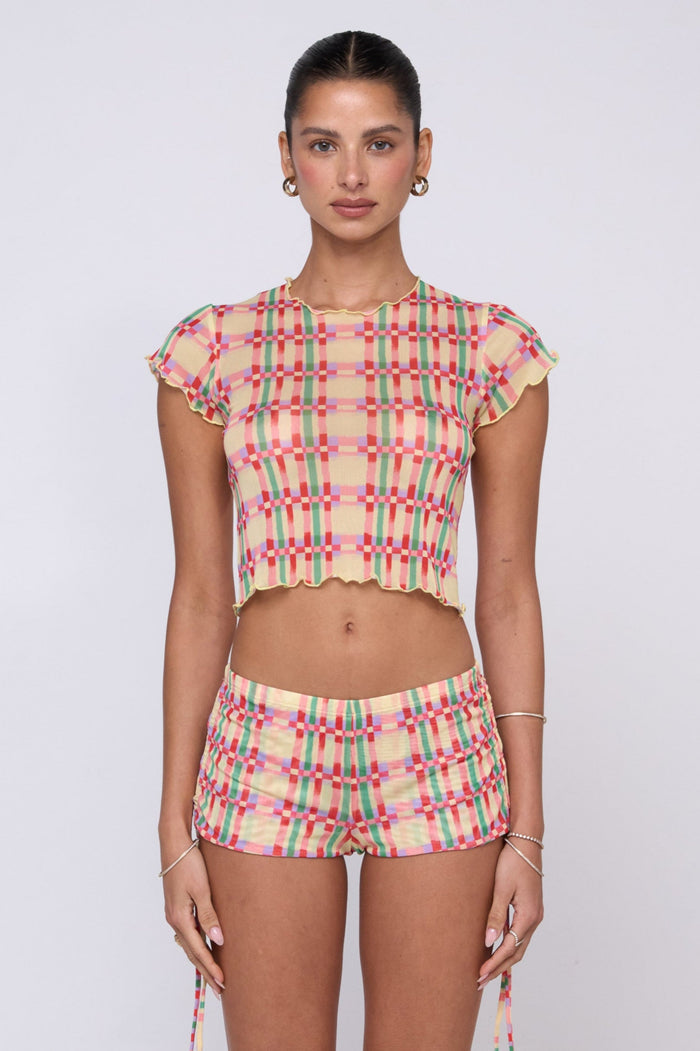 This is an image of Micro Shorts in Plaid - RESA featuring a model wearing the dress