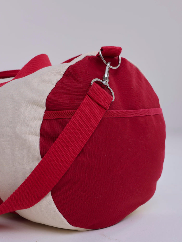 Red and beige bag with a strap on a white background