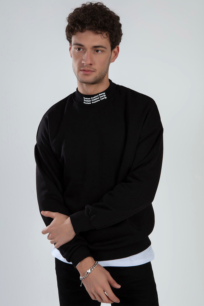 Men's black Lucas sweatshirt with oversized fit and 'Radiate Positive Energy' text on the high neckline collar.