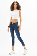 Model wears the white Luna Essential Ribbed Tank Top with dark wash skinny jeans and white sneakers.