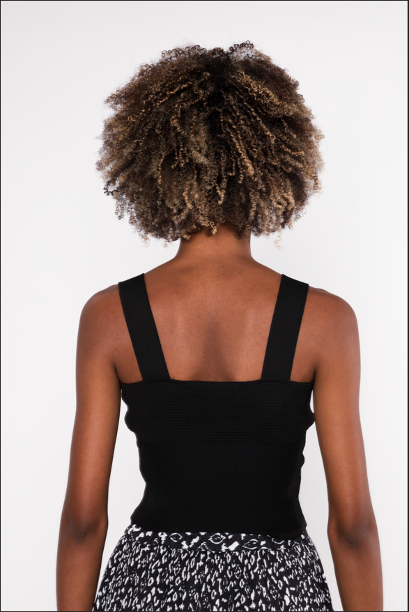 Back view of the Luna ribbed black tank top with thick straps and a minimalist streetwear fit on a model.