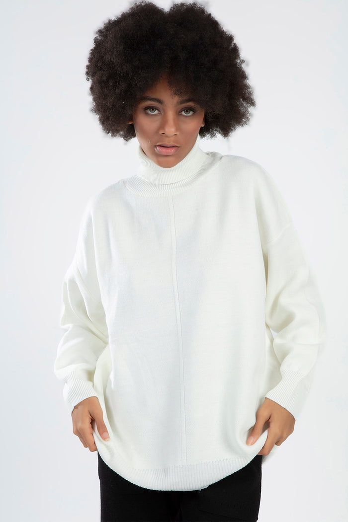 Model wearing the Mabel Cream Knit Sweater, a white oversized turtleneck with dropped shoulders and ribbed cuffs.