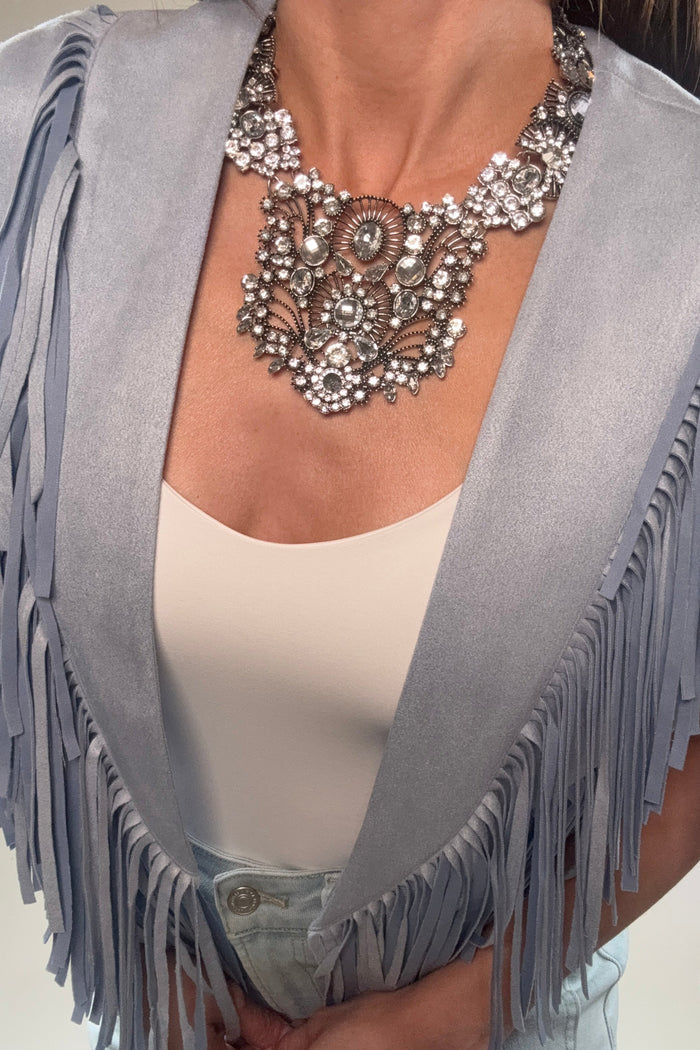 Silver-tone wide collar statement necklace with crystal embellishment and a bold dimensional bib-style design.