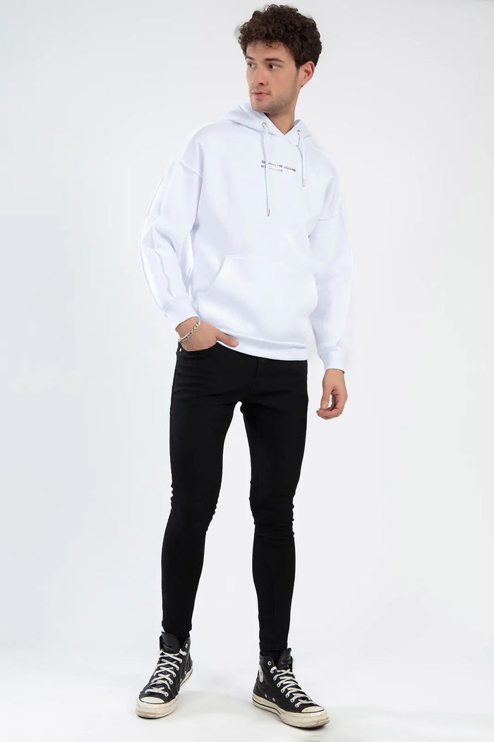 Model wearing Mark Black Super Skinny Trendy Denim jeans with a white hoodie and high-top sneakers.