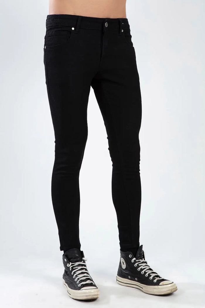Men wearing Mark Black super skinny denim jeans in a deep black wash with a trendy slim fit and high-top sneakers.