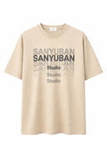 Beige graphic t-shirt with SANYUBAN Studio text print, short sleeves, casual style.