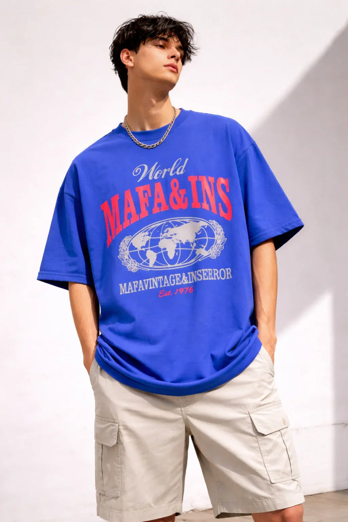 Man wearing oversized blue graphic t-shirt and beige cargo shorts, casual streetwear style