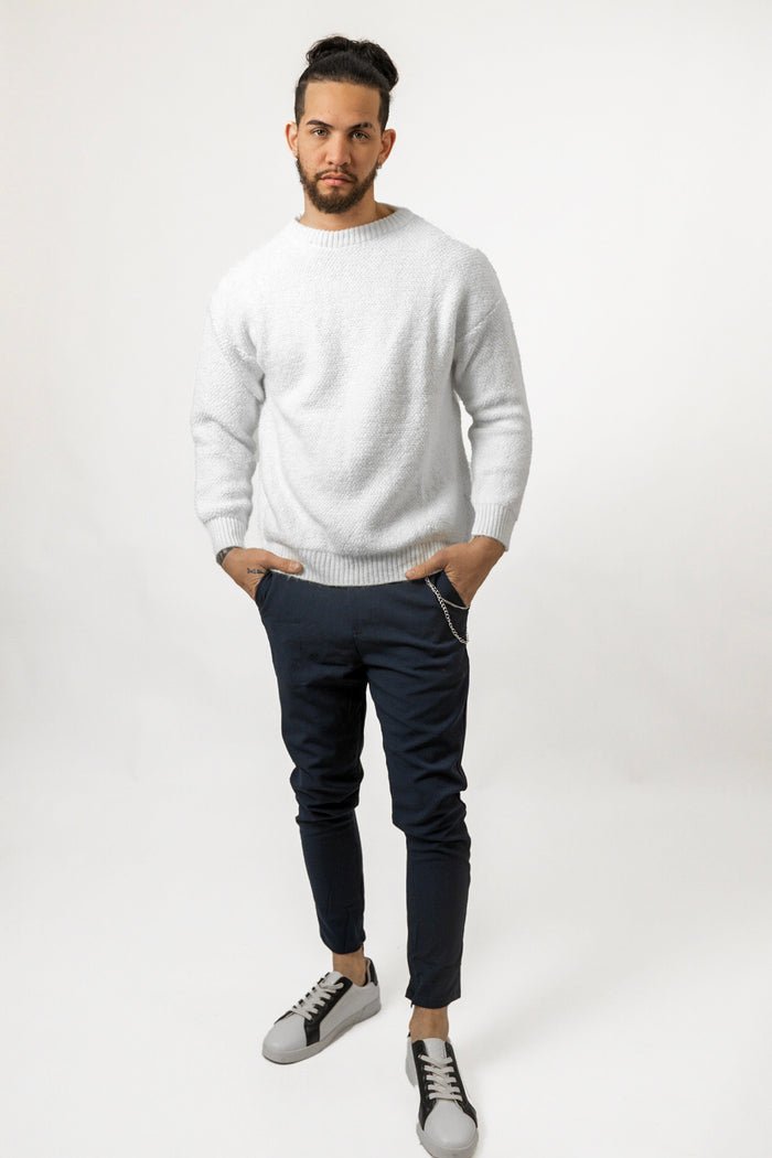 Man in white fuzzy Miles Top boucle sweater with navy trousers and sneakers, showing trendy streetwear style.