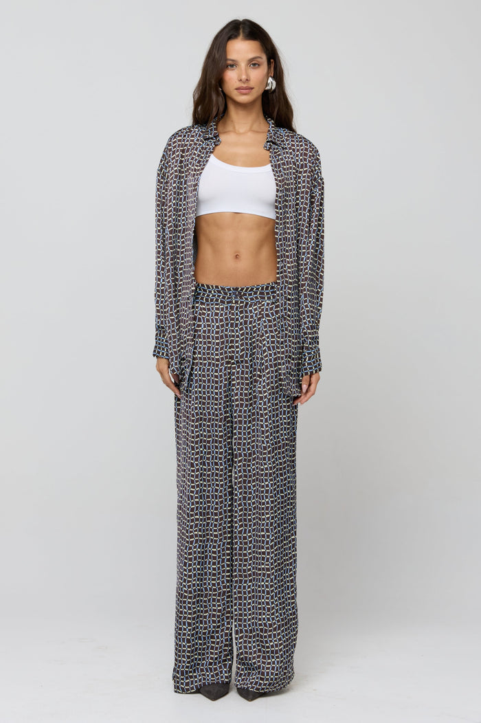 This is an image of Monica Blouse in Tide - RESA featuring a model wearing the dress