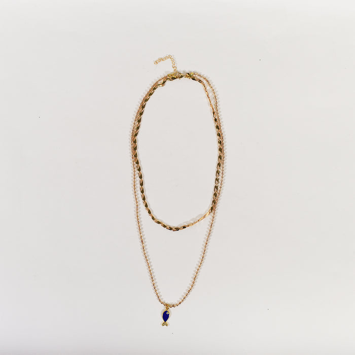Layered golden necklace set featuring a textured choker and a long ball chain with a blue fish pendant.