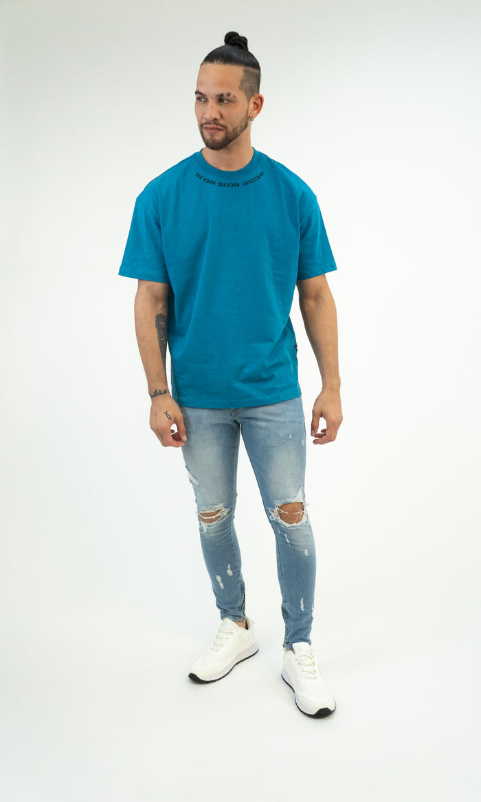 Model wearing Neil Jeans Men's Blue Washed Distressed Skinny Jeans with knee rips and light fading on a white background.