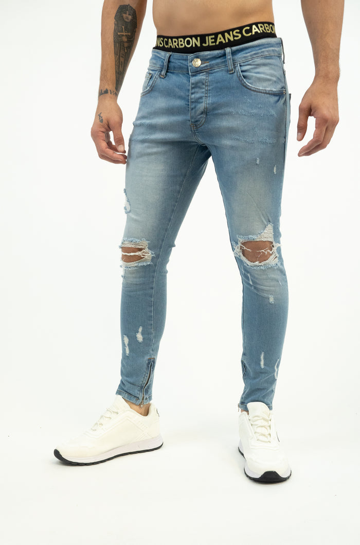 Neil Jeans: Men's light blue washed denim with distressed knees, skinny fit, ankle zippers, and Carbon Jeans waistband.