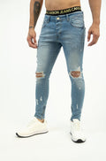 Neil Jeans: Men's light blue washed denim with distressed knees, skinny fit, ankle zippers, and Carbon Jeans waistband.