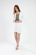 Model wearing the Nina cream jacket set, a white two-piece skirt and cropped blazer outfit for women.