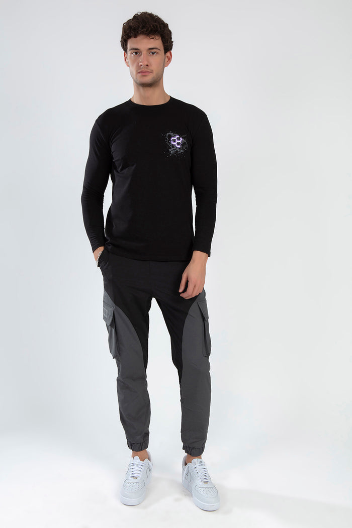 Not Now Pants - Men's black and grey wide leg cargo joggers with side pockets and a tapered fit, styled with white sneakers.