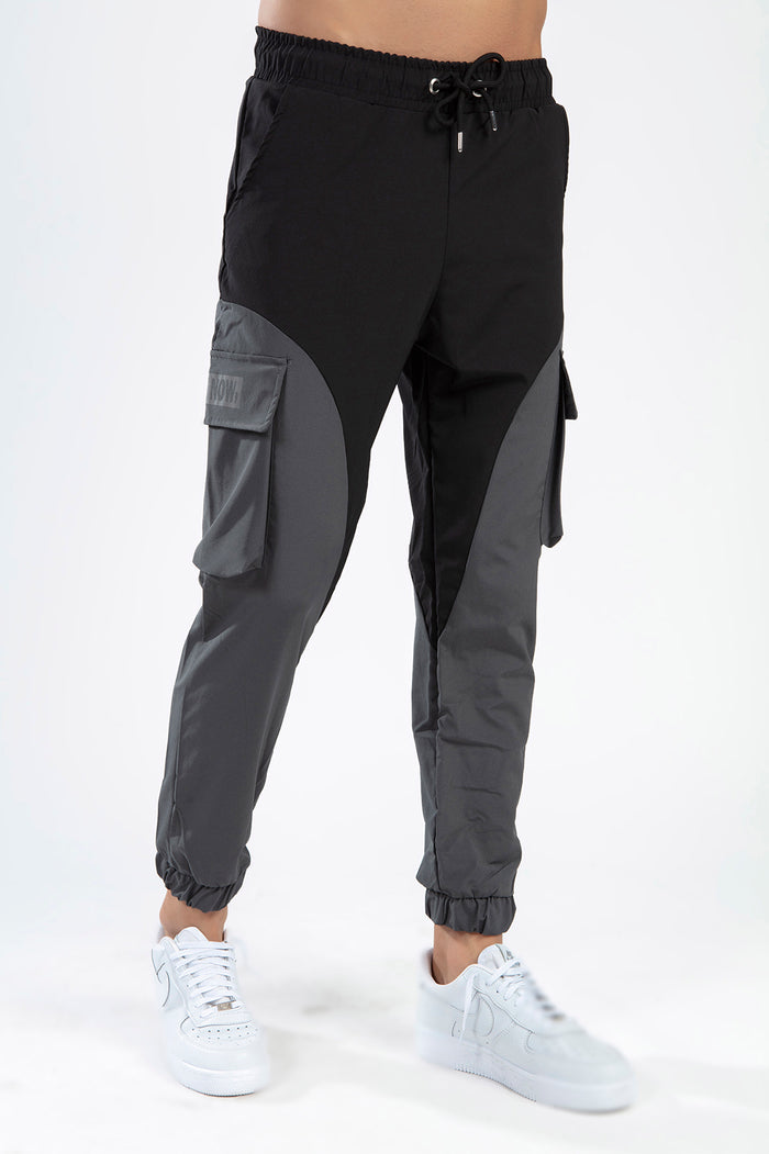 Not Now Pants: Black and grey wide-leg cargo joggers with drawstring waist and streetwear utility pockets.