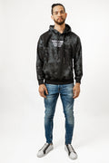 Model wearing a black tie-dye Only Human Hoodie by Carbon Jeans, a streetwear sweatshirt with white chest graphic.