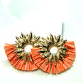 Orange and gold statement earrings with an oversized circular shape, textured ruffle edging, and metallic gold accents.