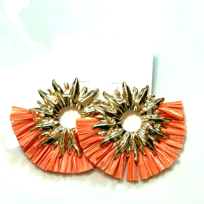 Orange and gold statement earrings with an oversized circular shape, textured ruffle edging, and metallic gold accents.