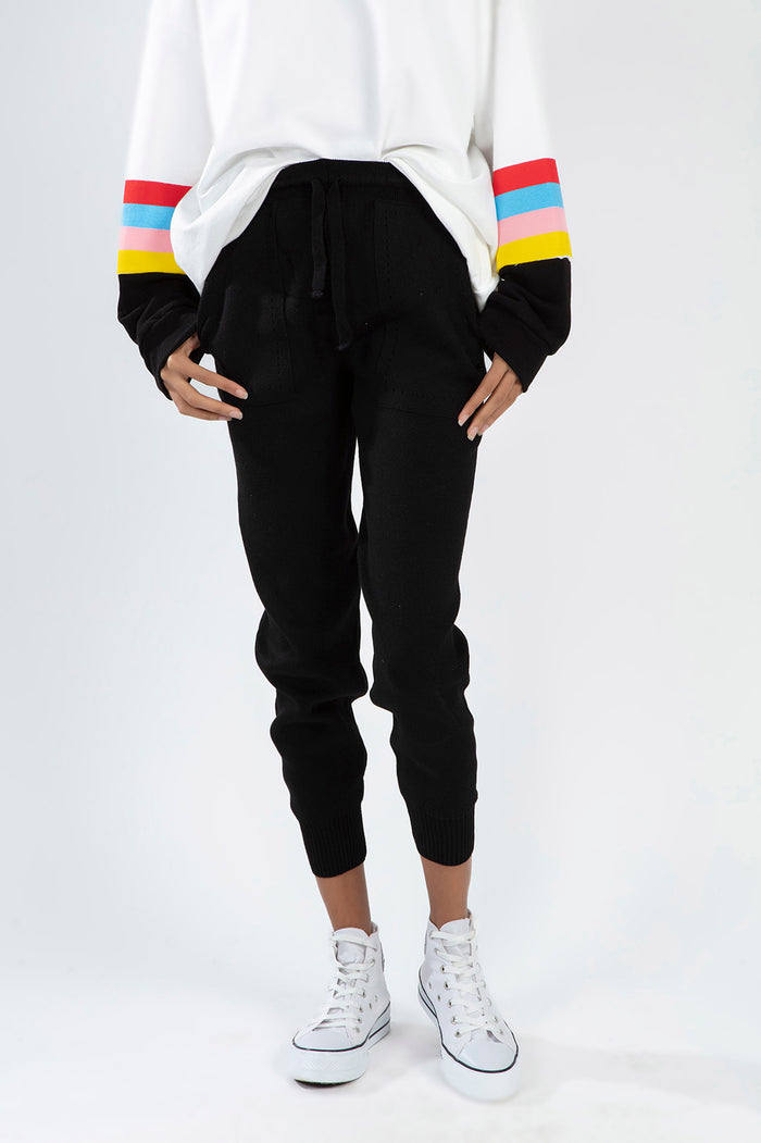 Close-up of black Paris knit joggers with drawstring waist and pockets, part of a trendy matching streetwear set.