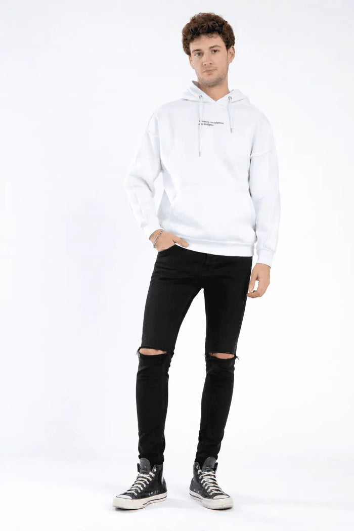 Model wearing Paul Slim Fit Black Denim with knee distressing, paired with a white hoodie and high-top sneakers.