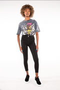 Model in an oversized grey acid wash tiger graphic tee and black high-waisted skinny jeans.