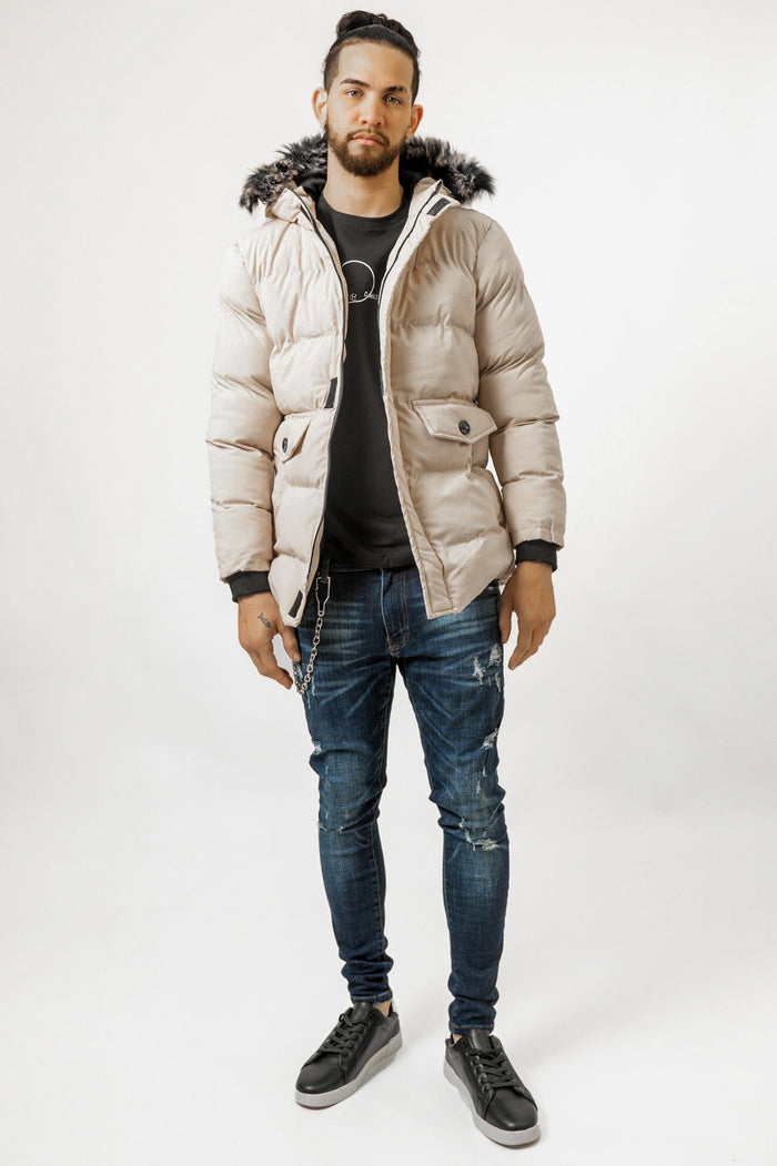 Men's Philip Puffer Coat in cream with faux-fur hood, paired with distressed jeans for a streetwear winter look.