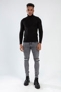 RAFAEL Super Skinny Fit Grey Jeans in Carbon wash with distressed knees on a model in a black turtleneck and boots.