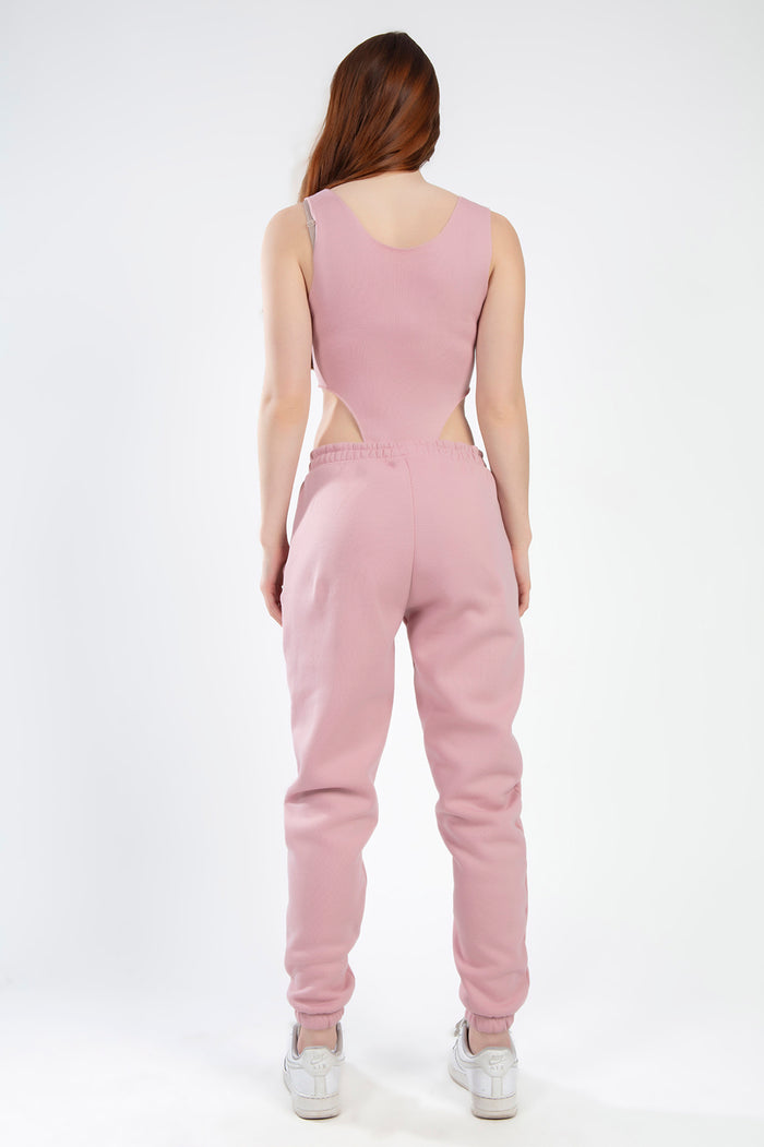 Back view of a woman wearing the salmon Remi Bodysuit Set with a cutout bodysuit and matching ribbed jogger pants.