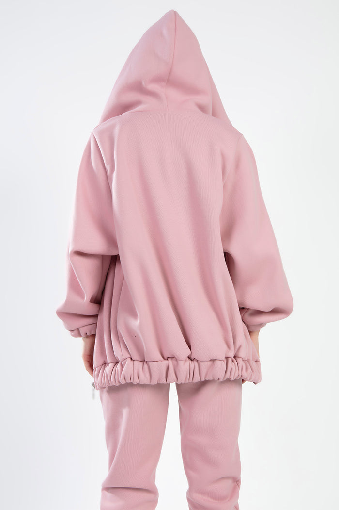 Back view of the salmon pink Remi Jacket Set featuring an oversized hooded jacket and matching joggers.