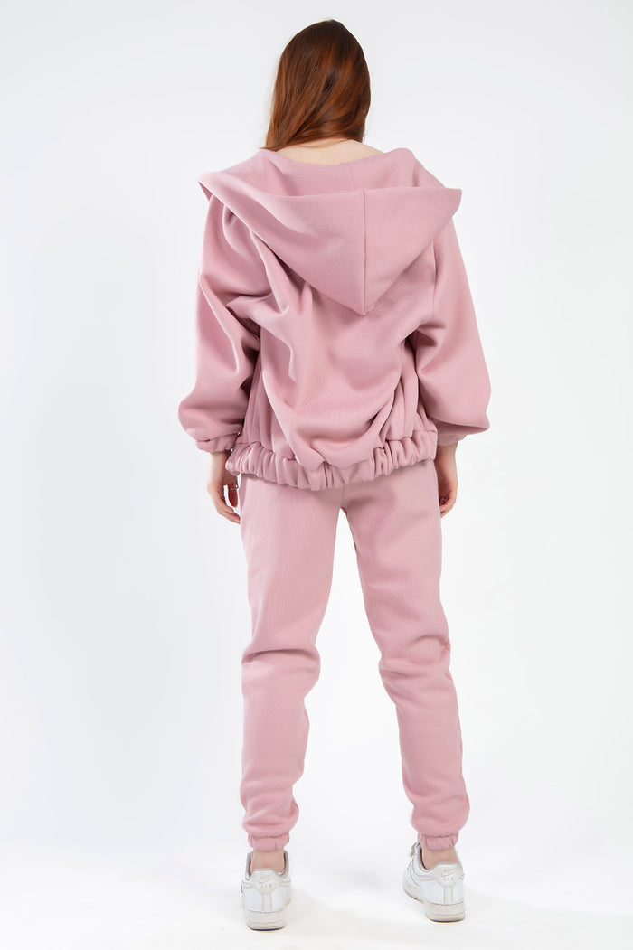 Back view of the Remi salmon pink two-piece fleece lounge set featuring an oversized hoodie and matching joggers.