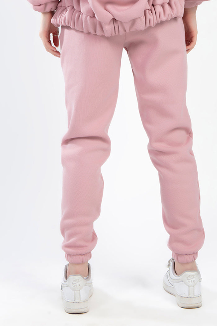 Rear view of Remi Salmon Two-Piece Pants Set showing high-waisted fleece joggers with elastic cuffs and matching hoodie.