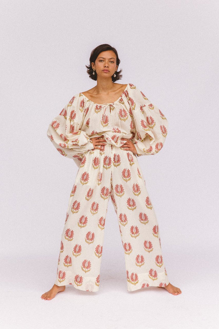 Ria Blouse Strawberry Cream — outdoor lifestyle portrait, model in natural setting, strawberry cream block print cotton blouse, Jaipur artisan made | Daughters of India