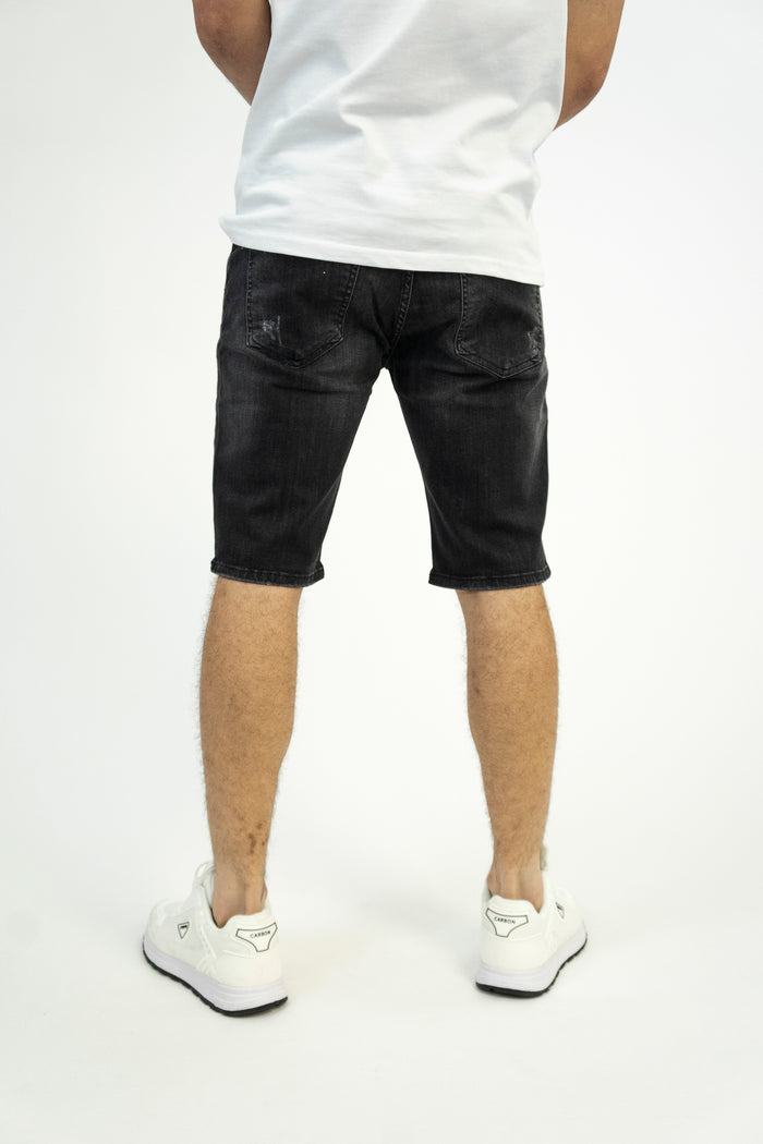 Rear view of Samuel Black Washed Denim Shorts for men by Carbon Jeans with distressed back pockets and a slim fit.