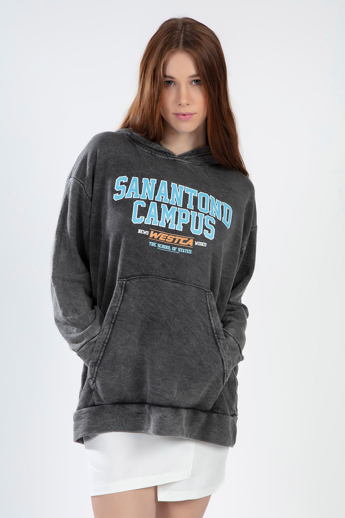 Model wearing a Sanatond Campus grey washed oversized hoodie with collegiate graphic on front.