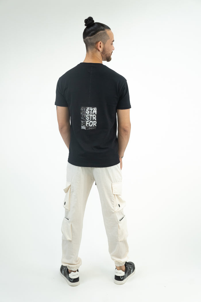 Back view of Sean cream cargo pants featuring a relaxed fit, multiple utility pockets, and elastic cuffs.