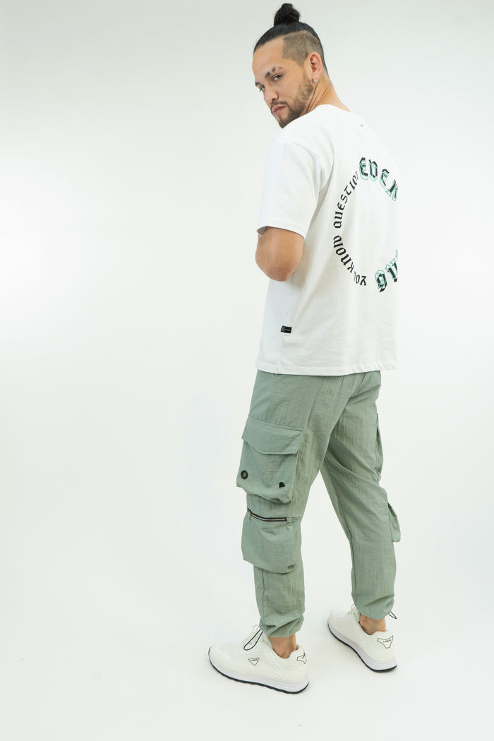 Model wearing Sean Relaxed Fit Pants in Mint, featuring cargo pockets and technical zippers for a Gen Z streetwear aesthetic.
