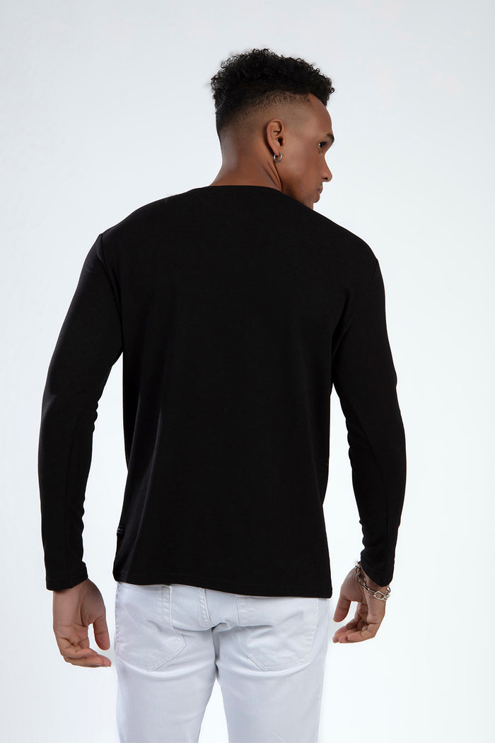Back view of the Show Must Go On black long sleeve graphic tee on a male model, showcasing a relaxed streetwear fit.