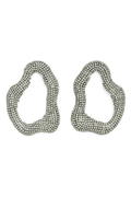 Silver-tone abstract statement earrings with an open sculptural shape covered in sparkling rhinestones.