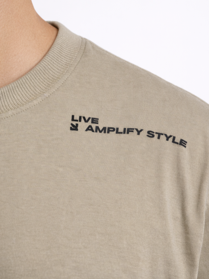 Light olive green t-shirt featuring a crew neck and black text graphic on the upper left side.